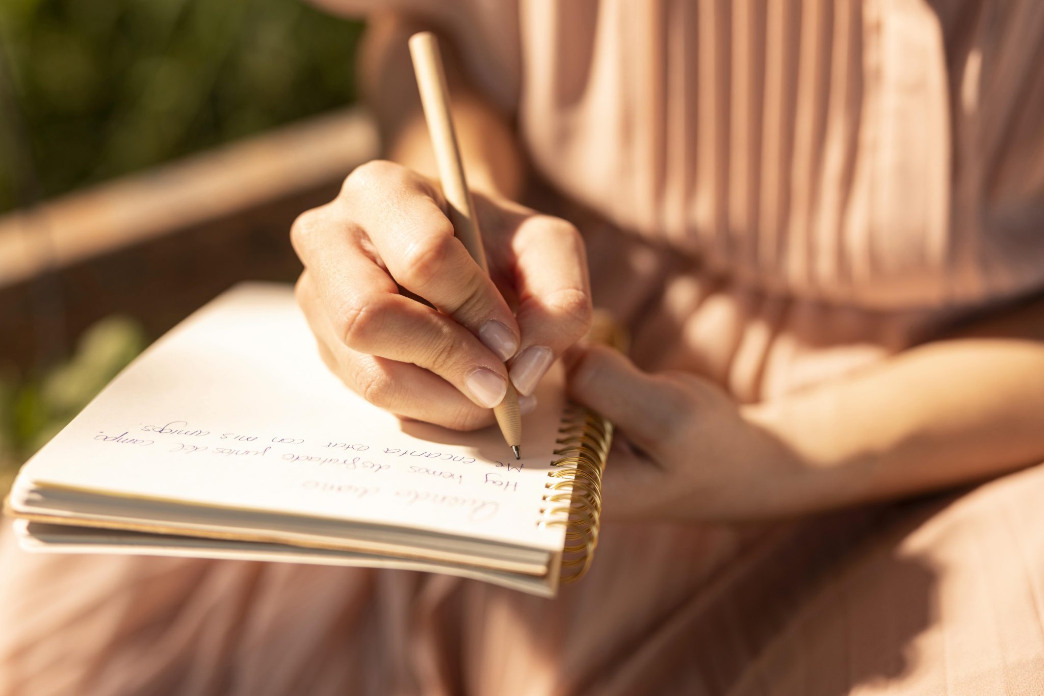 Close up of hand writing in notebook